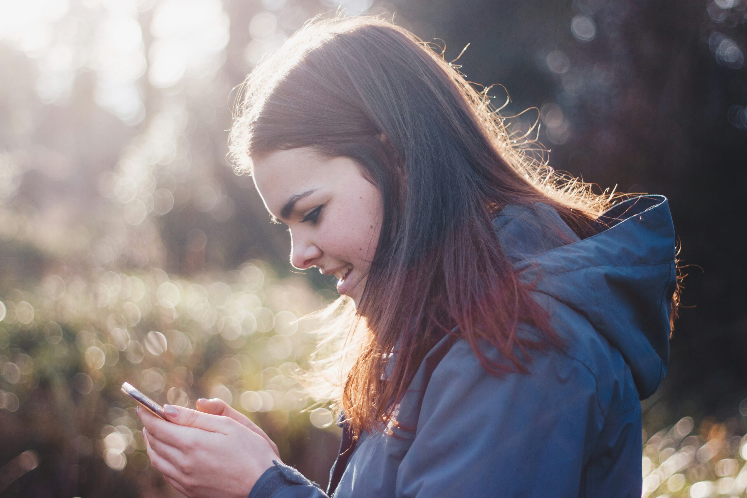 Child influencer using smartphone, navigating social media safely.